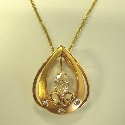 custom pear shaped diamond and gold pendant